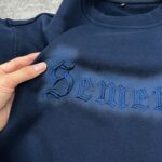 Embroidery logo detail on crewneck sweatshirt