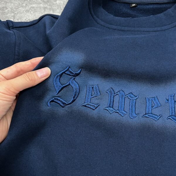 Embroidery logo detail on crewneck sweatshirt